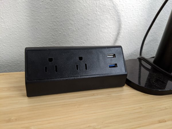 A desktop-mounted power outlet